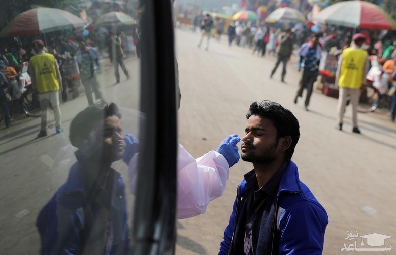 تست کرونا از شهروندان هندی در نزدیکی پایانه اتوبوسرانی شهر دهلی/ رویترز